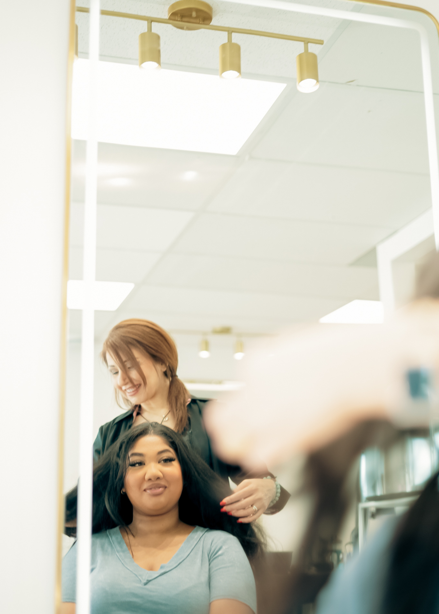 hair stylist with happy client